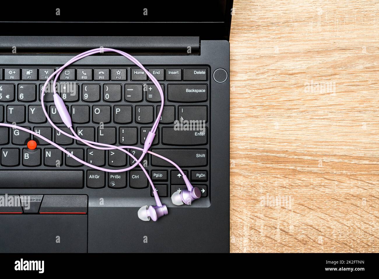 Earphones over laptop keyboard Stock Photo