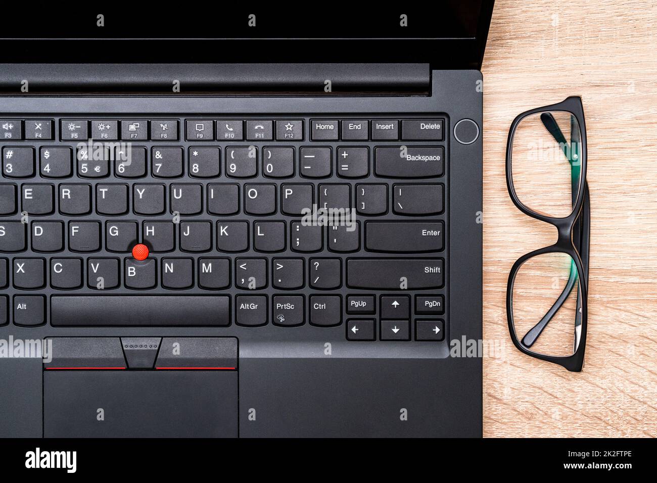 Top view of office desk with laptop  and glasses Stock Photo