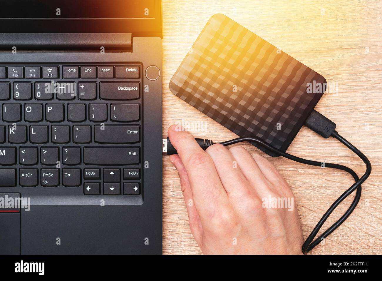 Plugging portable hdd into laptop USB slot Stock Photo