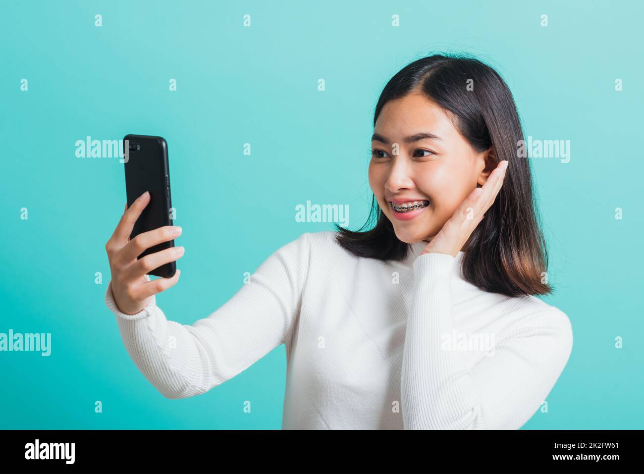 woman smile she using a smartphone to selfie photo Stock Photo