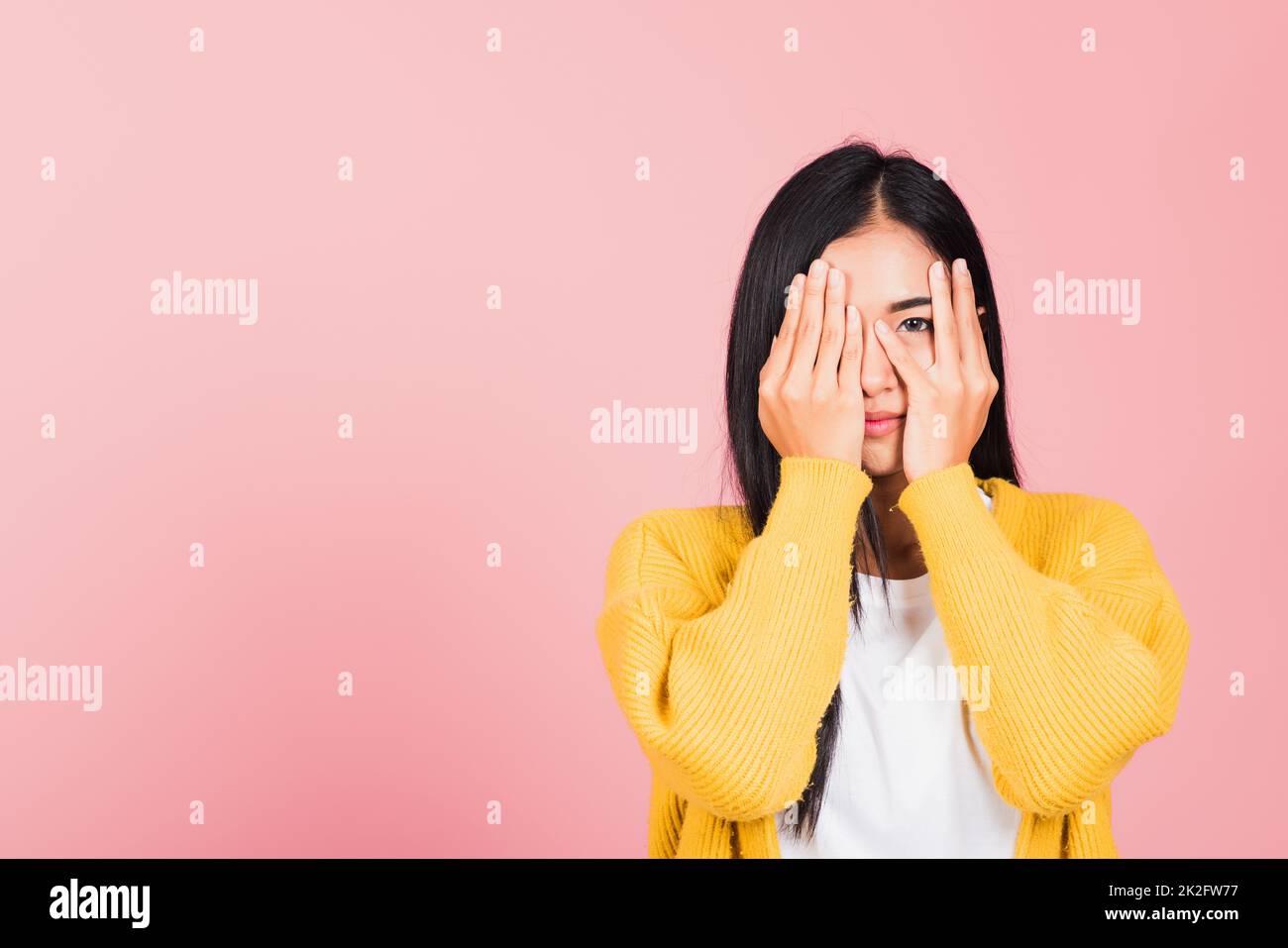 woman in depressed bad mood covering face with hands Stock Photo