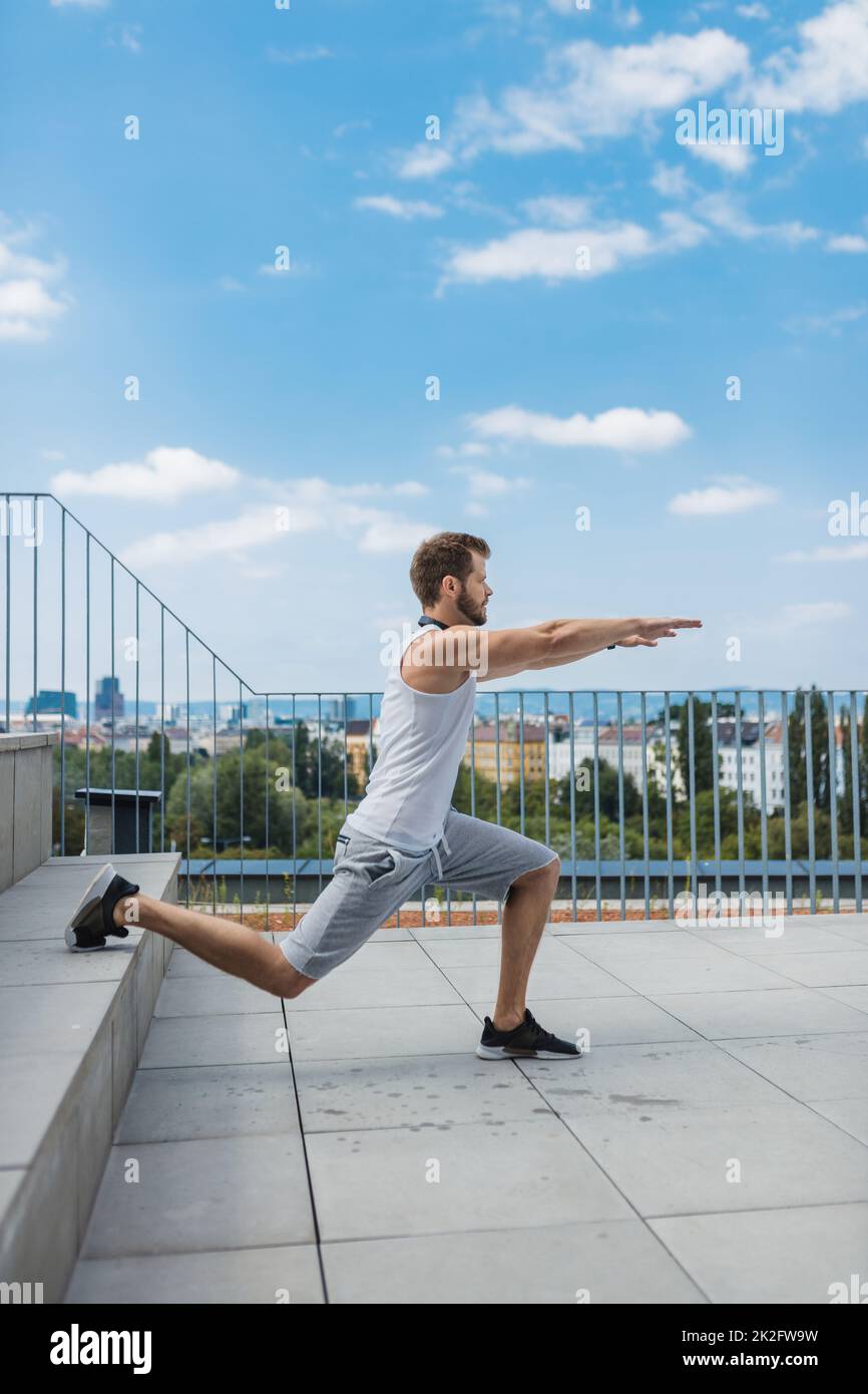 Handsome man training and working out outdoors Stock Photo
