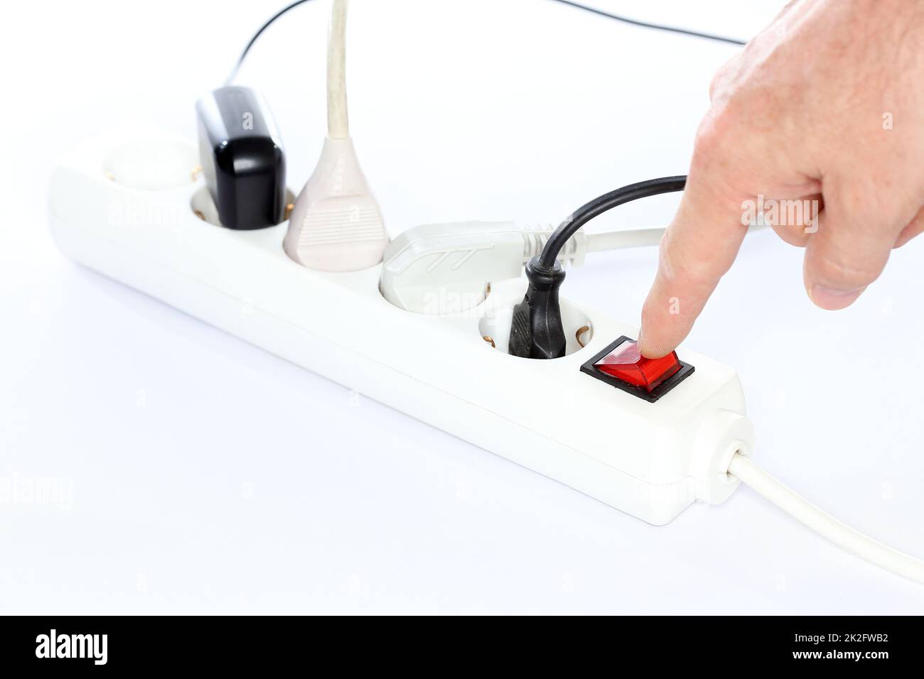 saving energy with finger is switching off a device Stock Photo