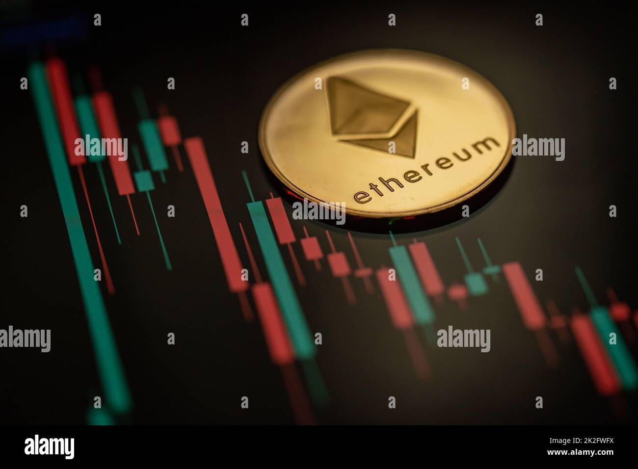 Gold Ethereum cryptocurrency with candle stick graph chart and digital background. Stock Photo