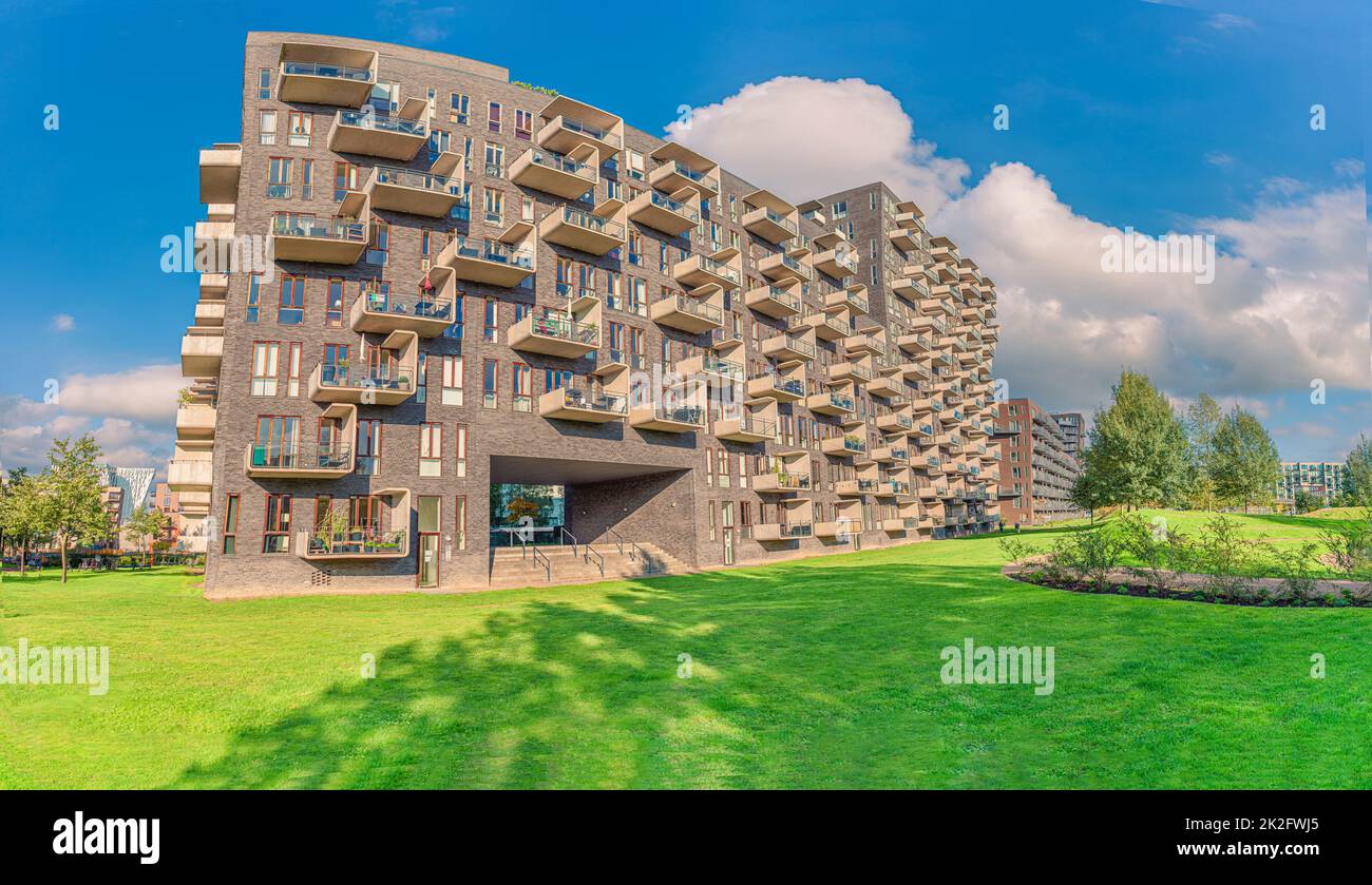 modern futuristic residential house with rectangular balconies near a green Byparken park in Ã˜restad city area. Copenhagen, Denmark Stock Photo