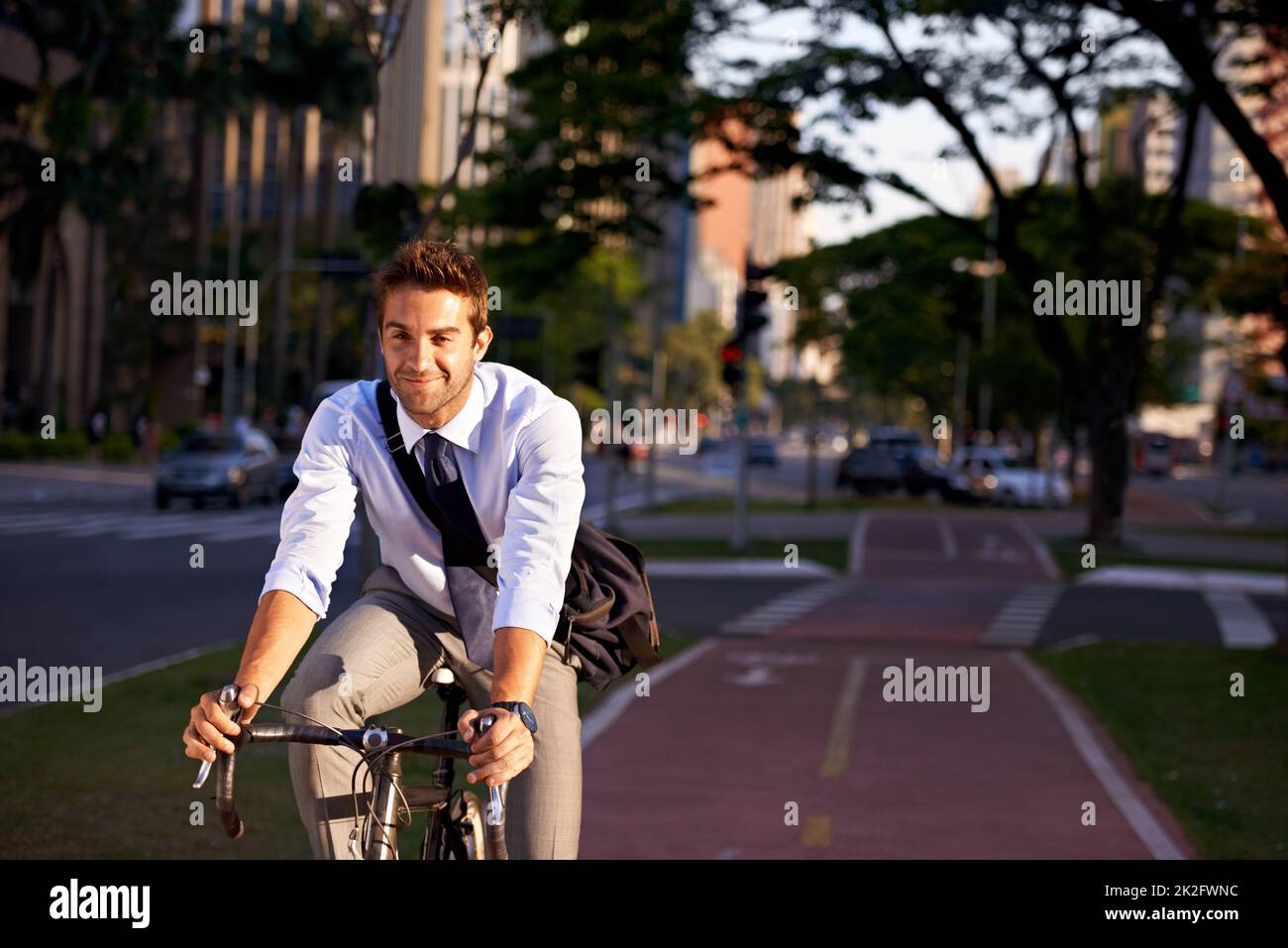 No gym membership needed. Shot of a businessman commuting to work with his bicycle. Stock Photo