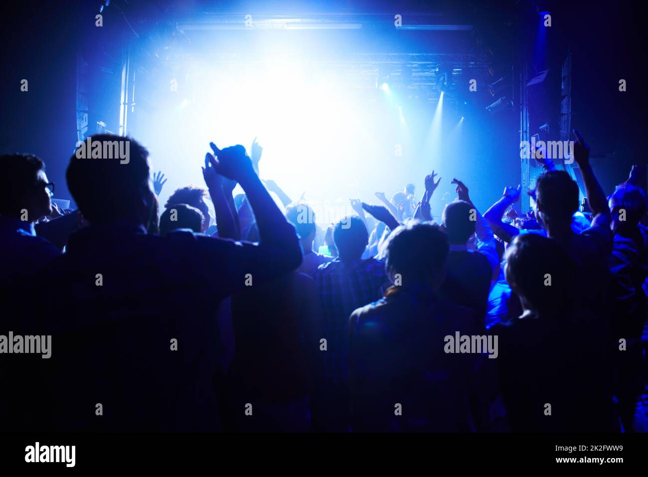 This concert is next level. A crowd of people cheering the band on st. Stock Photo