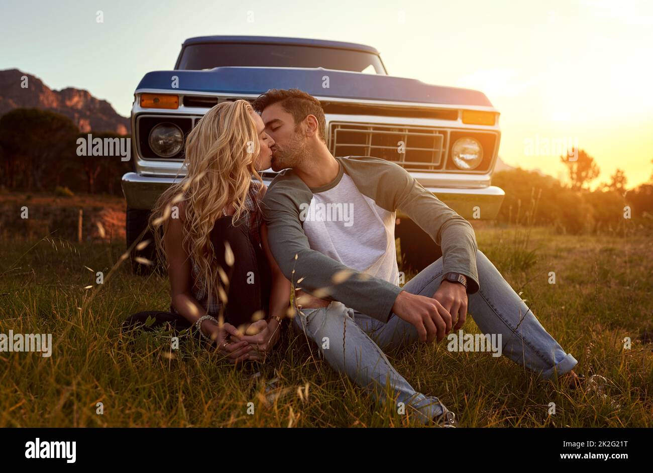 Letting their love blossom. Shot of an affectionate young couple on a roadtrip. Stock Photo