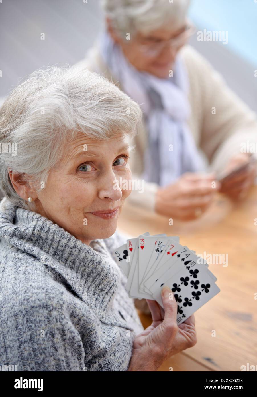 Helping the time pass with card games. Shot of senior citizens playing cards together. Stock Photo