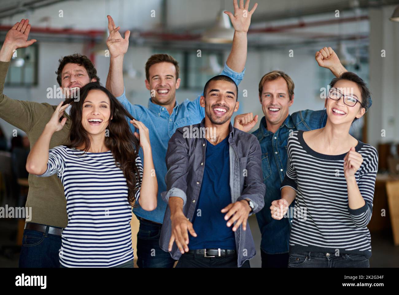 Now thats what I call team spirit. Joyous group of office staff jumping around and having fun together. Stock Photo