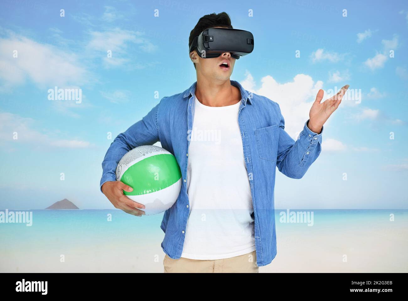 Its the getaway of my dreams. Shot of a young man wearing a VR headset superimposed over a beach landscape. Stock Photo