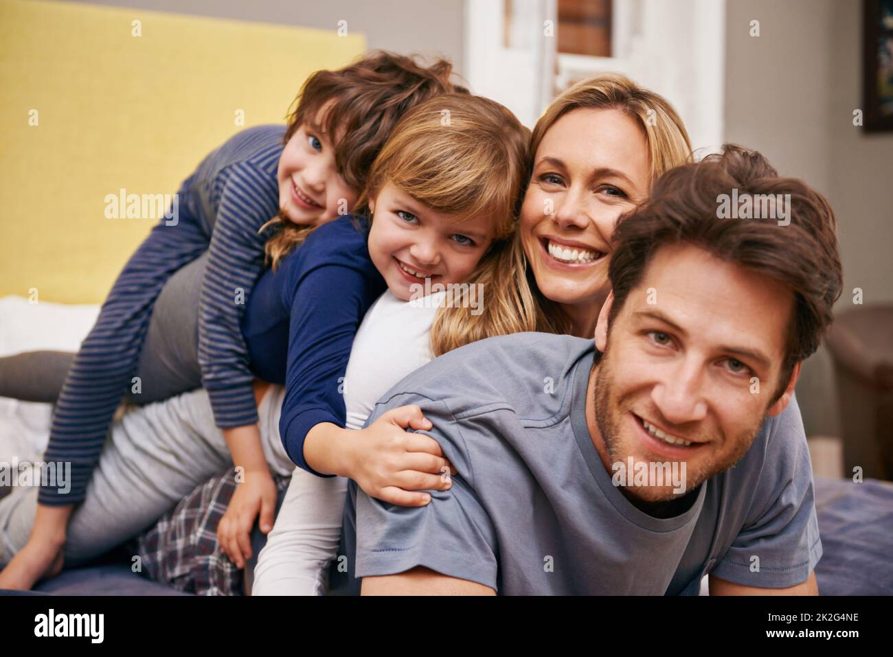 Bonding before bedtime. Portrait of a young family being playful at home. Stock Photo