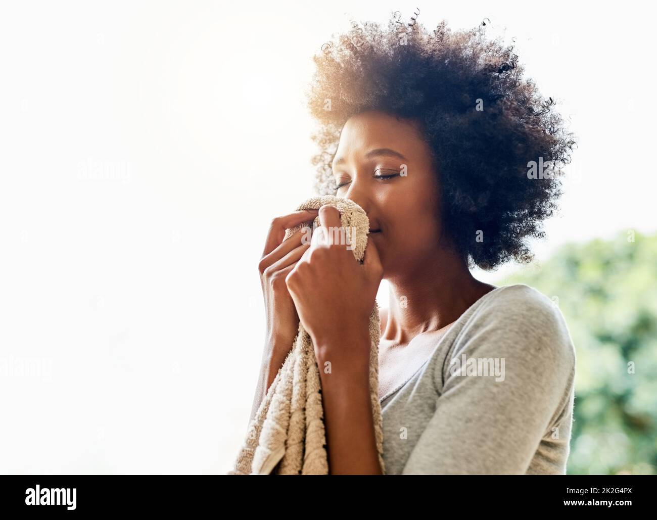 The amazing smell of clean laundry. Cropped shot of an attractive young