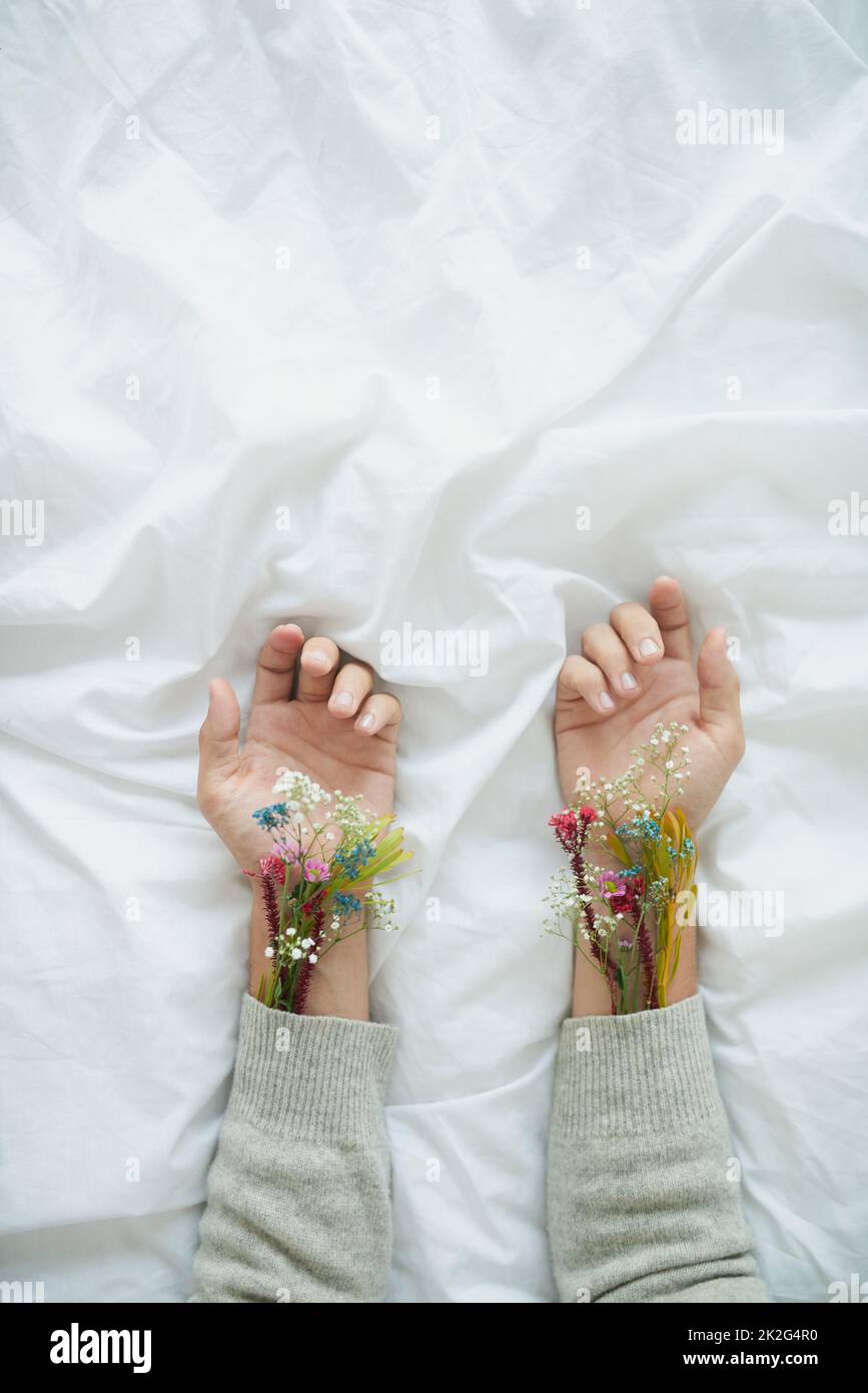 Sprouting flowers. Shot of plants growing from an unrecognizable persons sleeves placed next to each other. Stock Photo