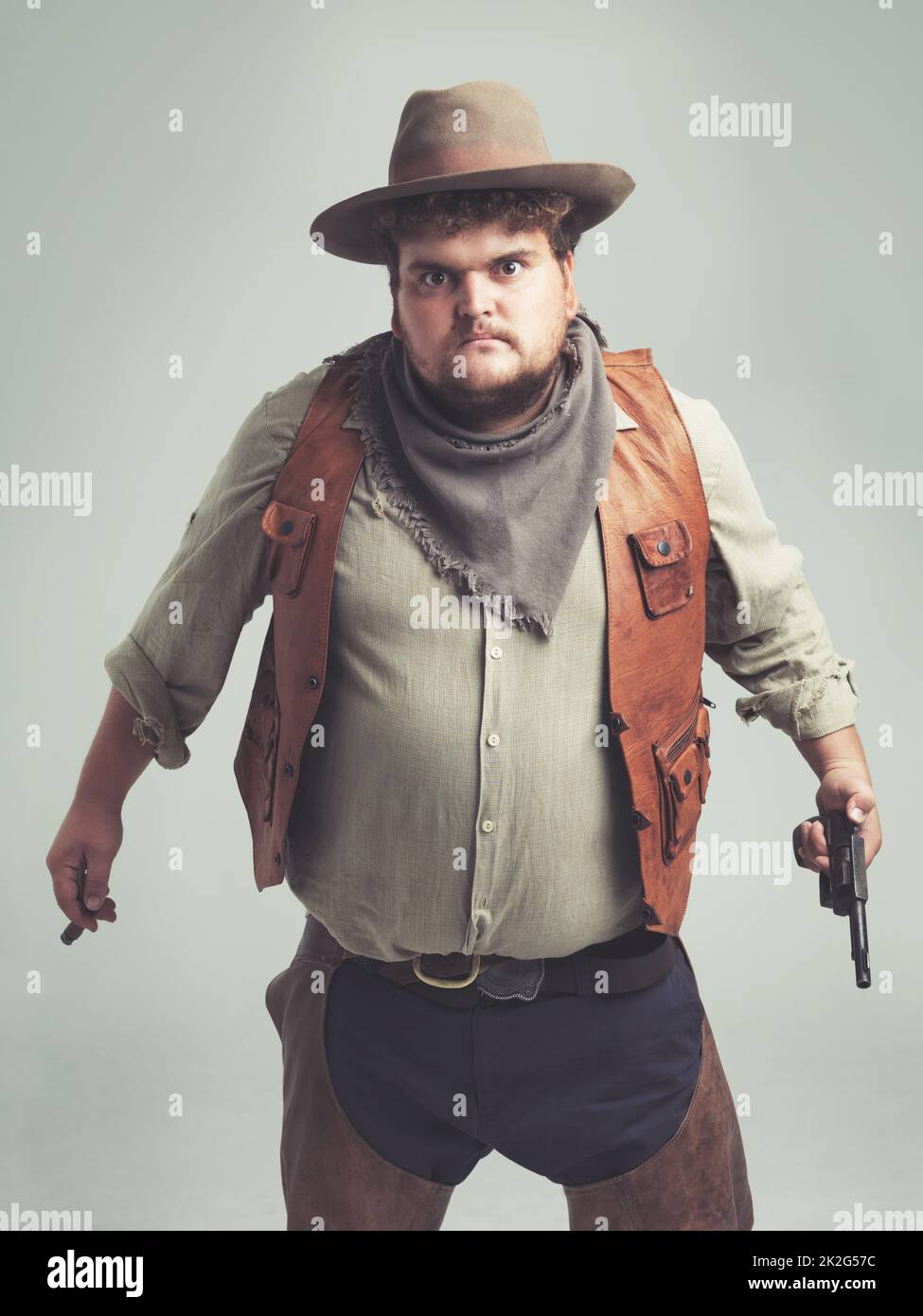 He said he was my best friend...Then comes back as a zombie and tries to eat  me Totally uncool. An overweight cowboy looking pretty intense Stock Photo  - Alamy