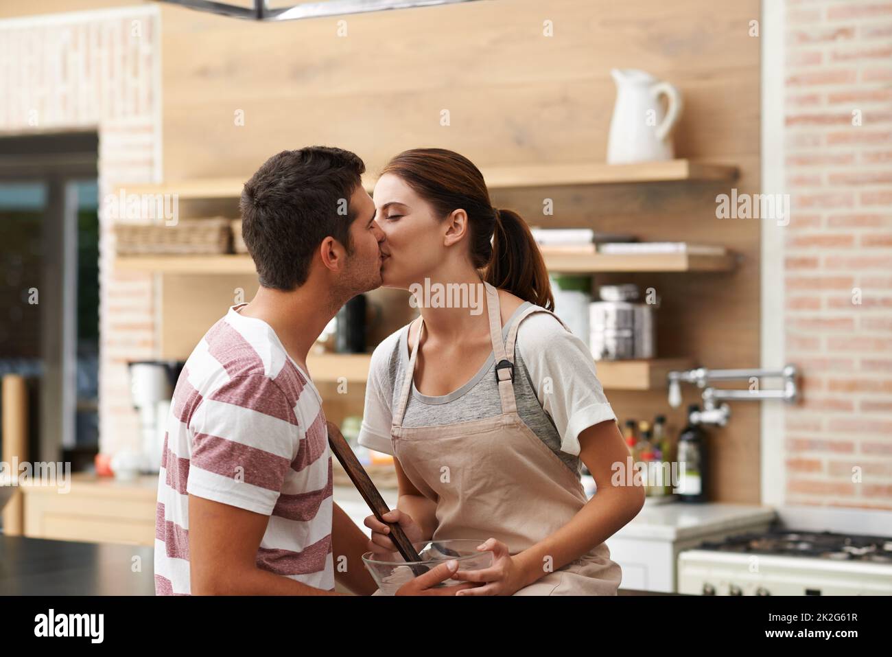 Kisses In The Kitchen Cropped Shot Of A Young Couple Sharing A Kiss In   Kisses In The Kitchen Cropped Shot Of A Young Couple Sharing A Kiss In The Kitchen 2K2G61R 