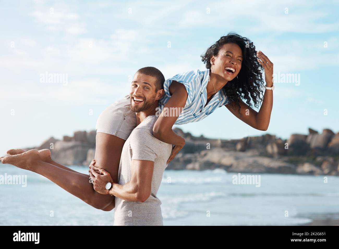 Summer fuels a sense of endless fun. Shot of a young couple enjoying some quality time together at the beach. Stock Photo