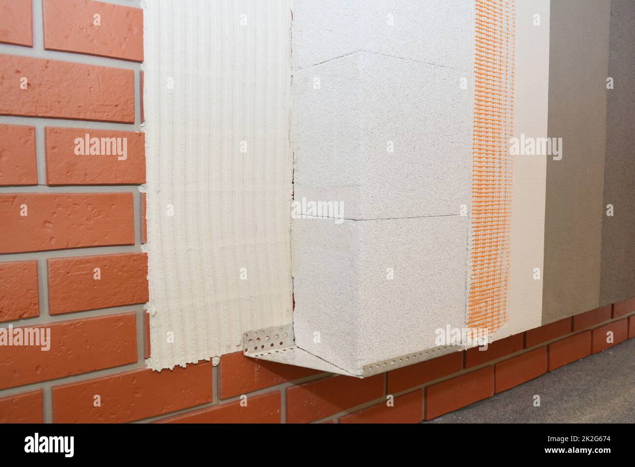 House brick wall renovation, insualtion with glue plastering layers,  reinforcment mesh, aerated concrete blocks, finishing render, stucco. External w Stock Photo