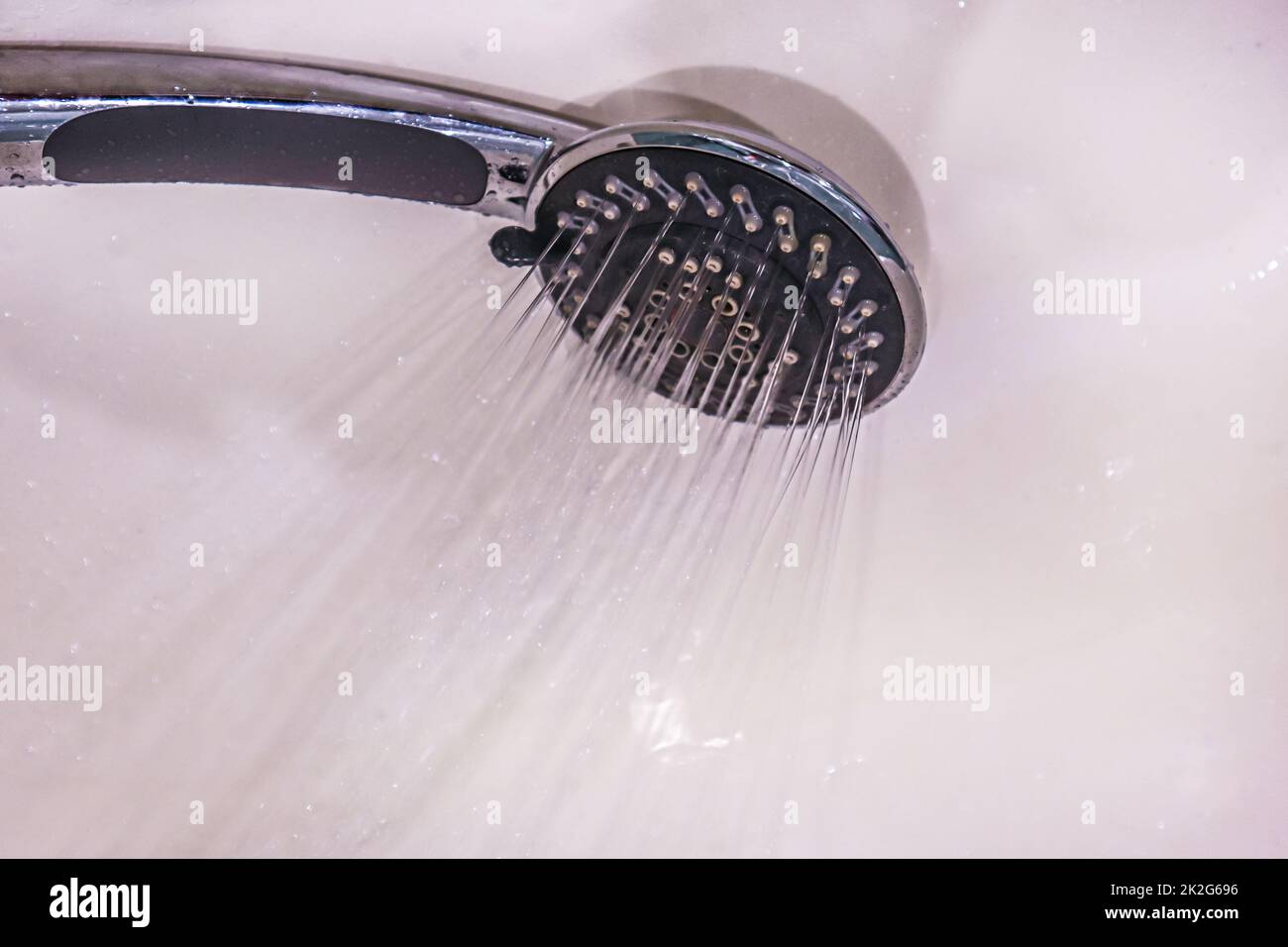 Drops of water fall from the watering can in the shower closeup. The