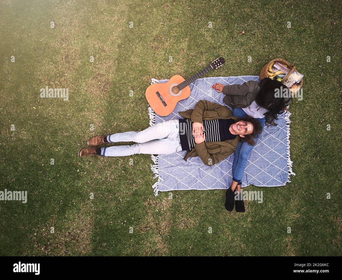 Romance in the park. High angle shot of a young couple having a romantic date in the park. Stock Photo