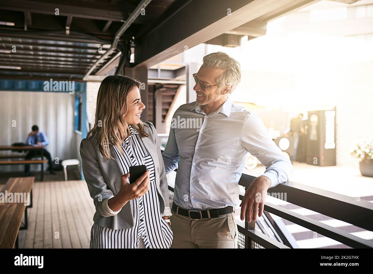 Taking their connection outdoors. Shot of two businesspeople using a cellphone outside. Stock Photo