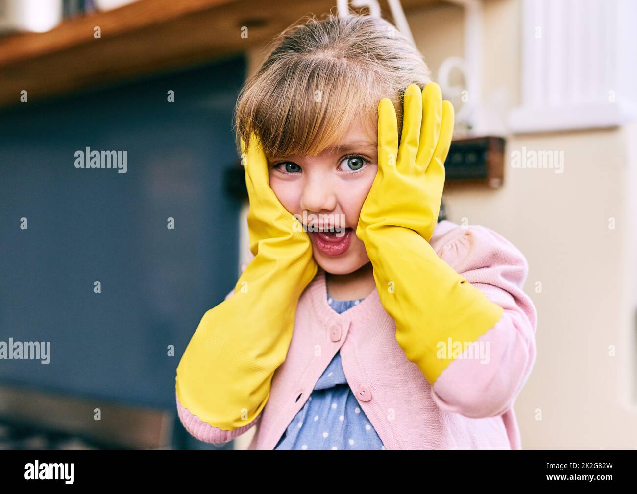 Oh no time to wash the dishes. Portrait of a surprised looking little