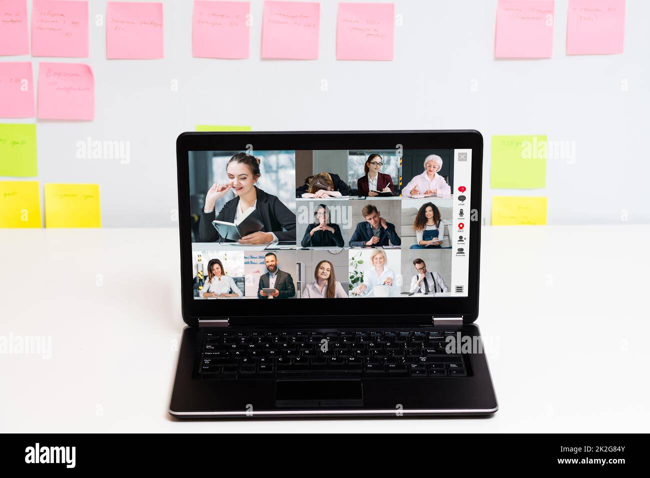 Corporate video call. Online teamwork. Virtual business meeting. Employees brainstorming in digital office on laptop screen at white workplace with st Stock Photo