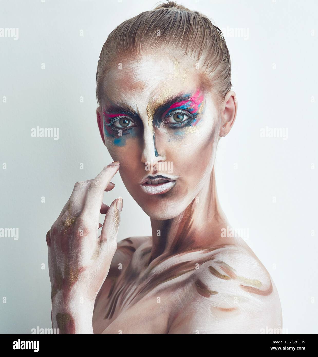 Beauty in art. Studio portrait of a young woman posing with paint on
