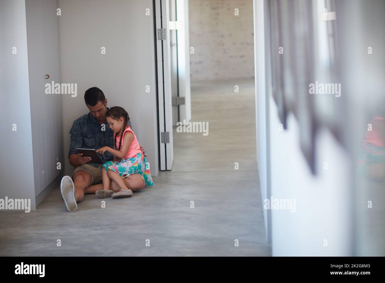 Online for some entertainment. Shot of a father and daughter spending time together at home. Stock Photo