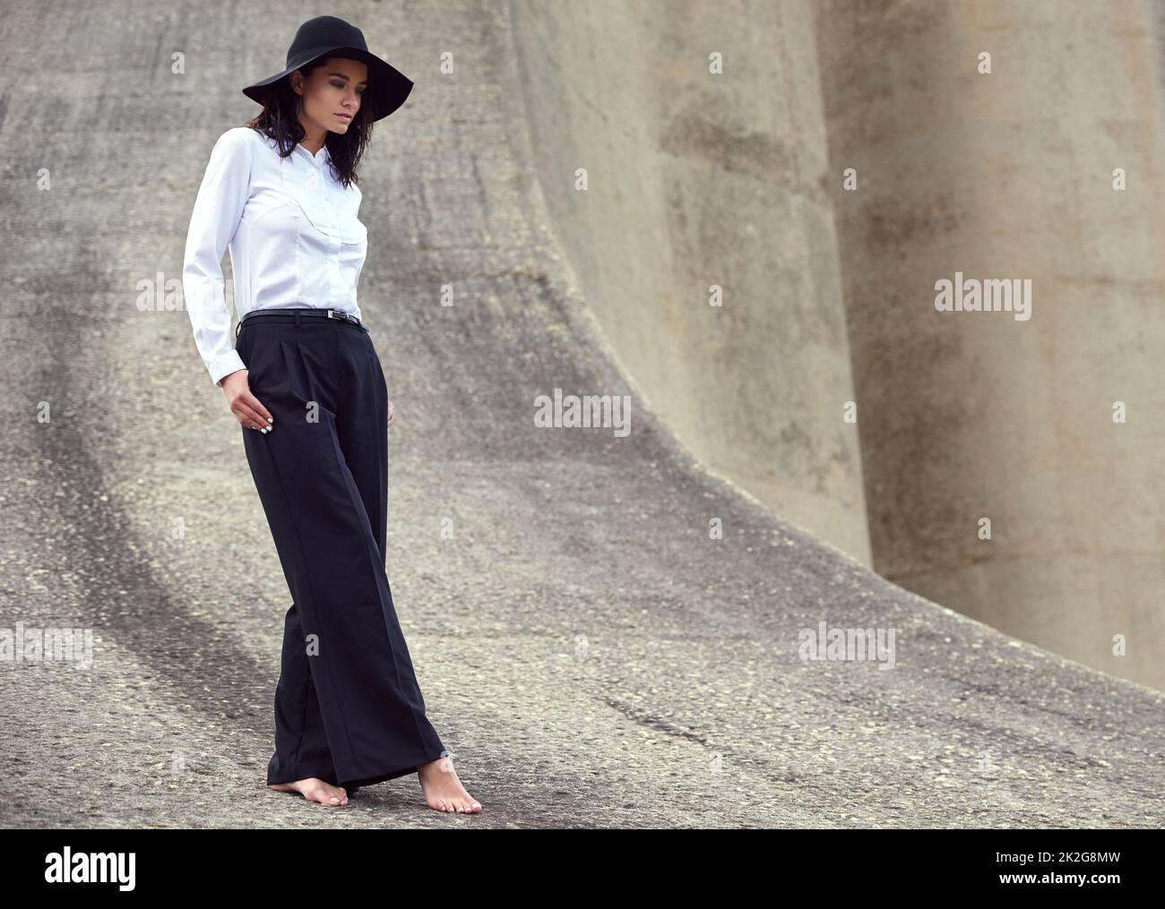 Fashion in an urban jungle. Full length shot of a beautiful fashion model posing in an empty urban setting. Stock Photo