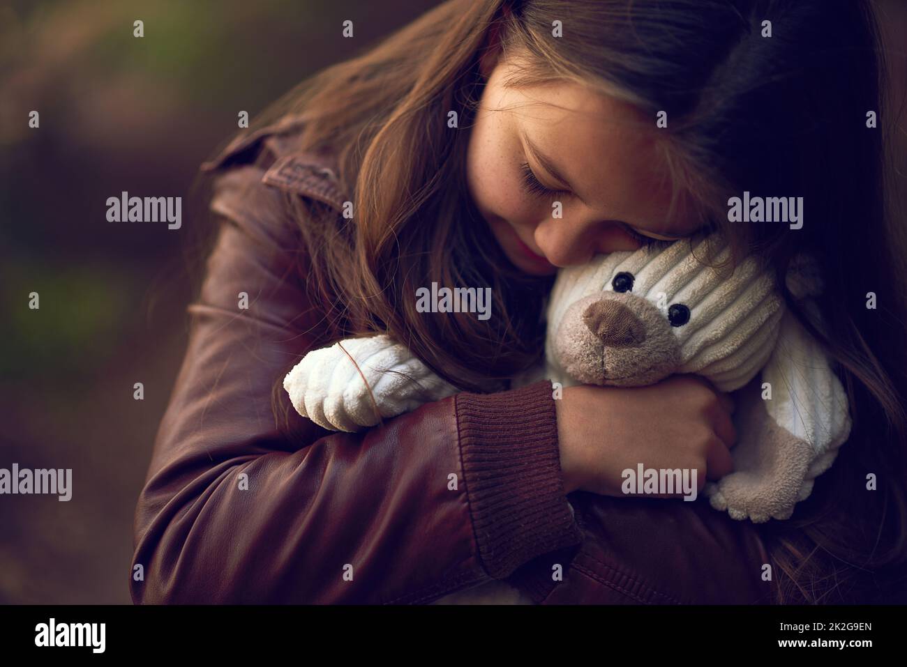 Teddy will always be my best buddy. Cropped shot of a young girl hugging her teddy bear outside. Stock Photo