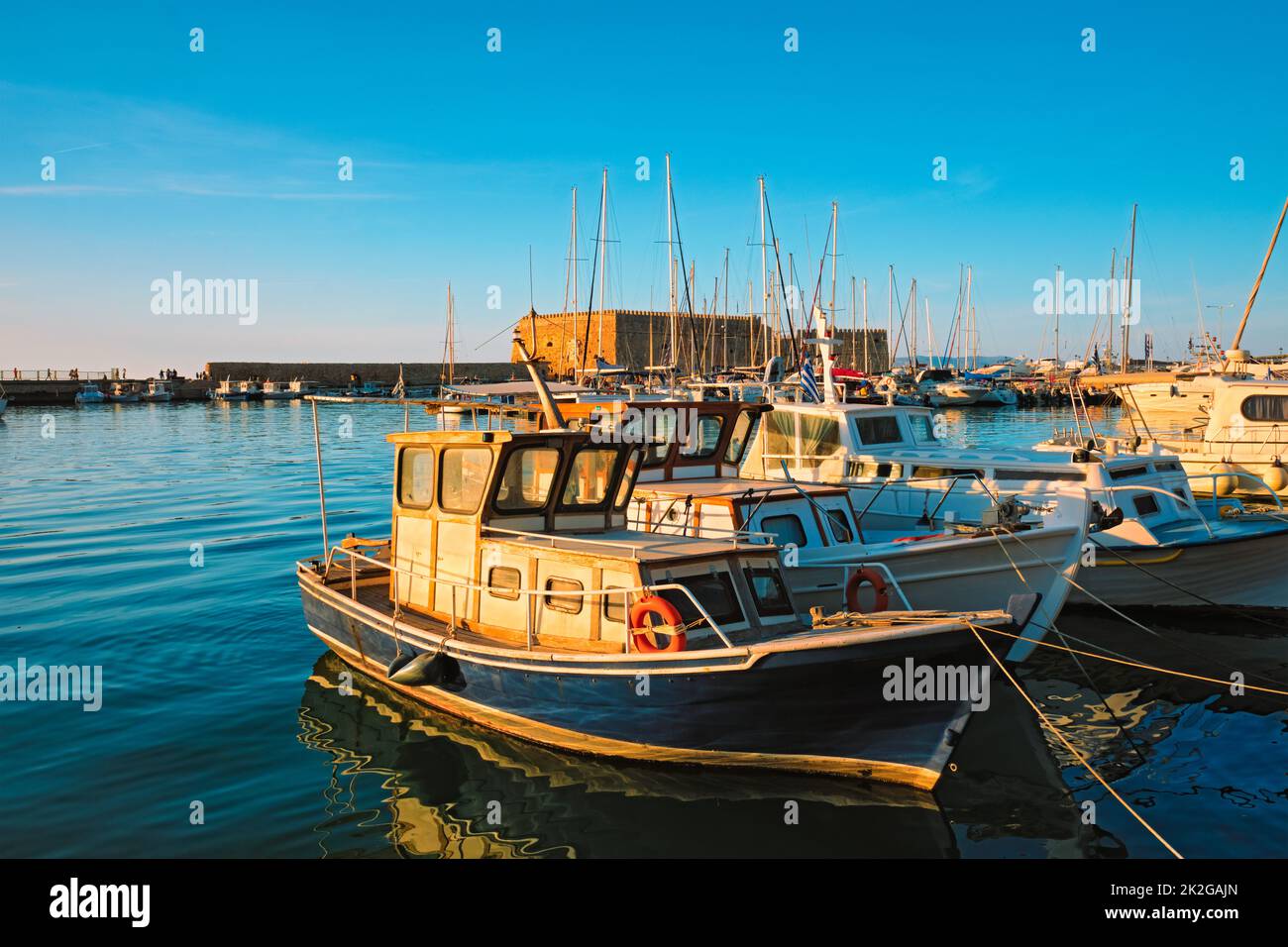 Venetian Fort in Heraklion and moored fishing boats, Crete Island, Greece Stock Photo