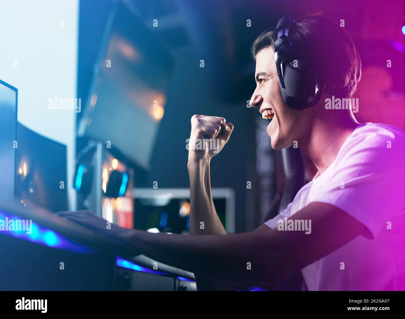 Lifes a game so level up. Shot of a young man cheering while playing computer games. Stock Photo