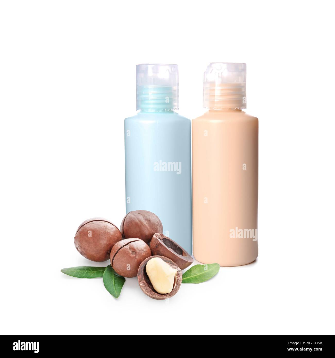 Bottles of natural cosmetics with macadamia nuts on white background