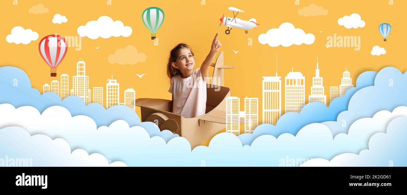 Little girl with cardboard airplane flying in drawn sky Stock Photo - Alamy