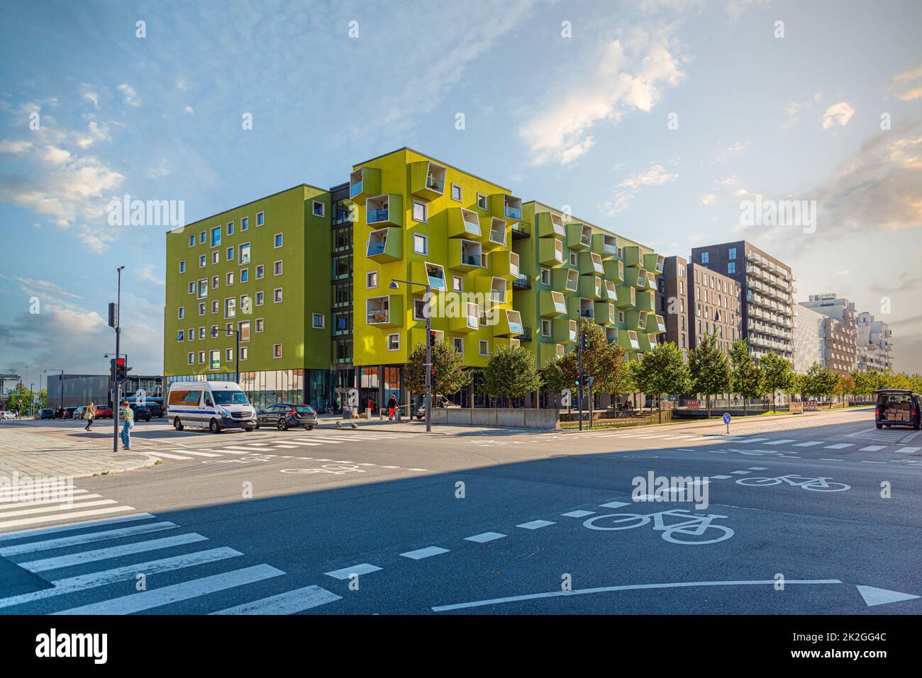 A modern residential building Ã˜restad plejecenter in bright light green color with windows and balconies in the form of cubes. Copenhagen, Denmark Stock Photo