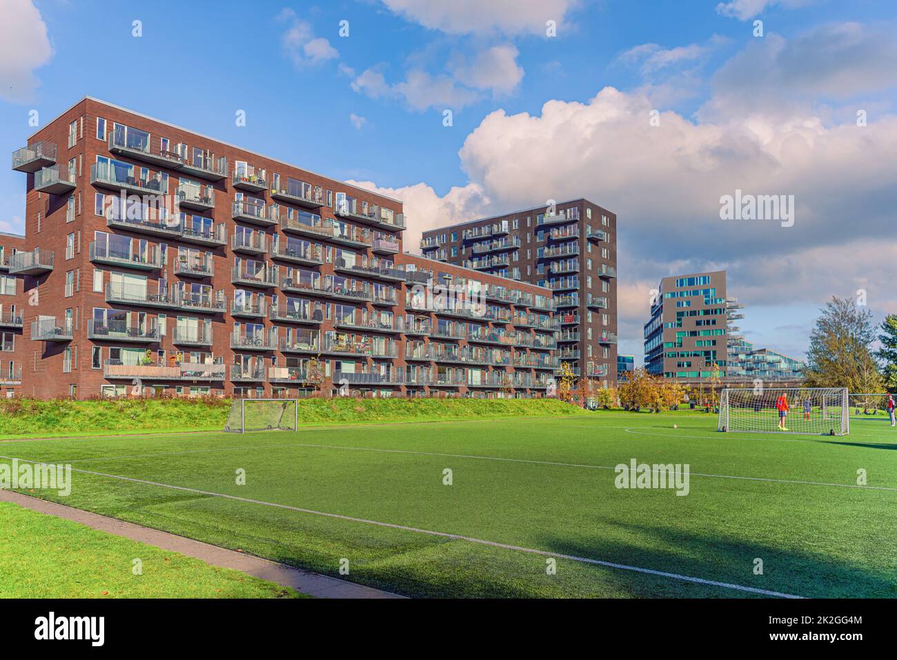 Modern brown residential apartment building near the Byparken park and football field in Ã˜restad. Copenhagen, Denmark Stock Photo