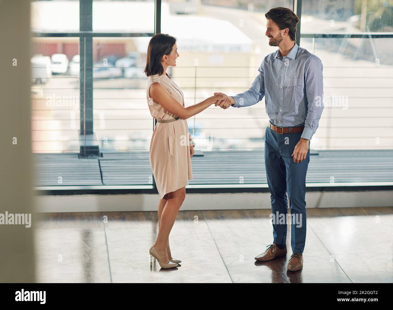 I cant wait to get started. Full length shot of two businesspeople shaking hands in the office. Stock Photo