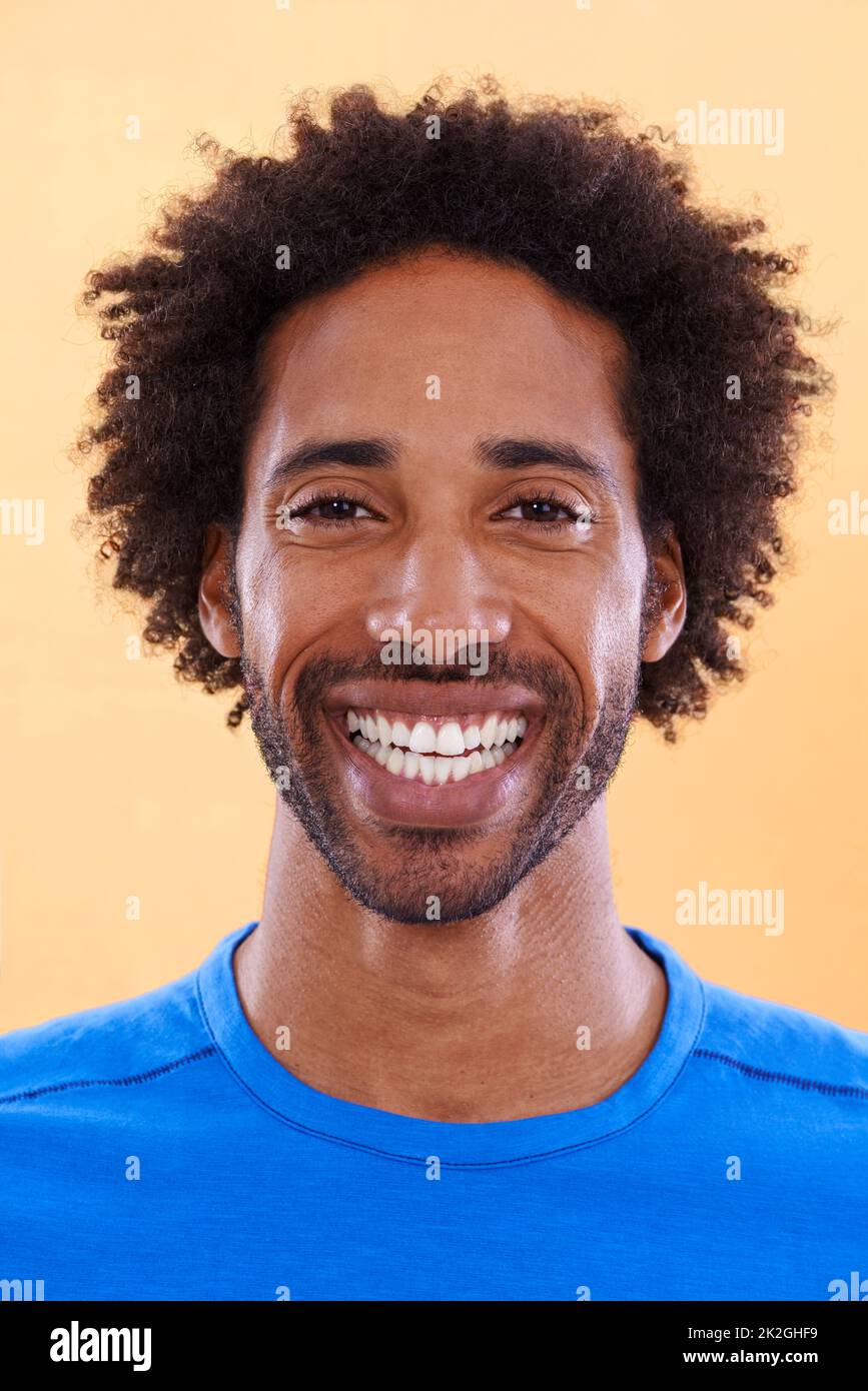 Showing off his brightest smile. A handsome young black man against a