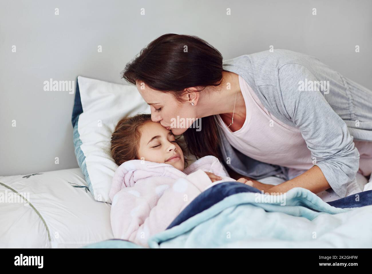 Sweet dreams and dont let the bedbugs bite. Cropped shot of a mother