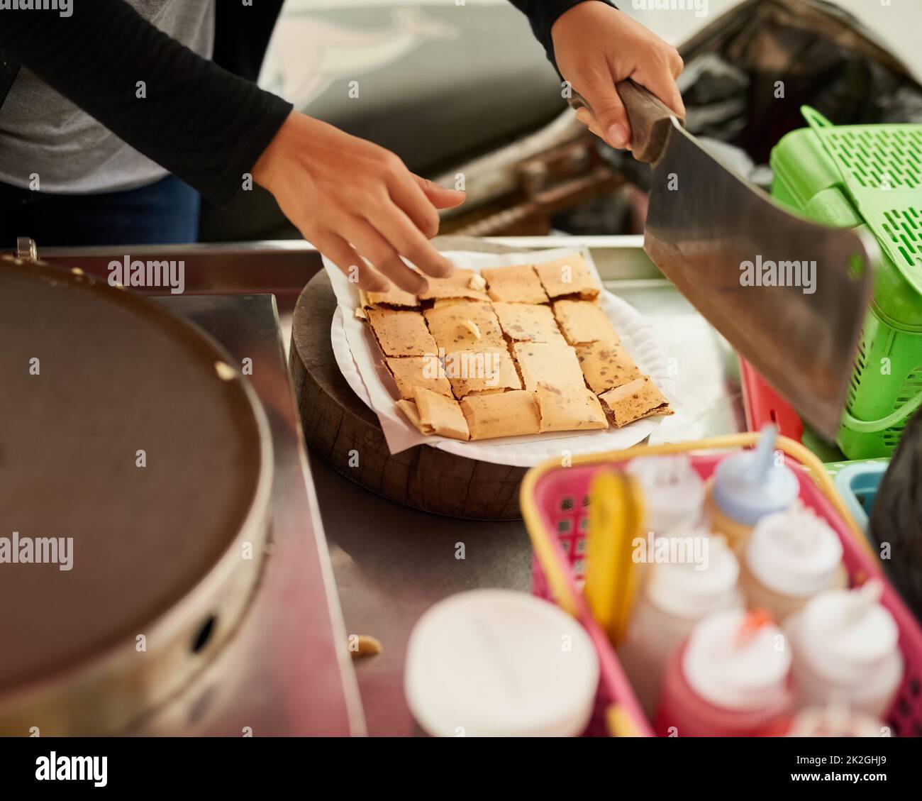 Fresh and delicious. Shot of an unidentifiable food vendor in Thailand preparing a tasty snack. Stock Photo