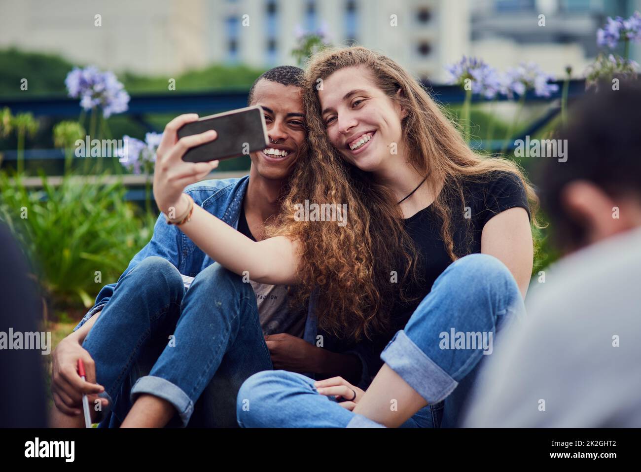 Making memories with my besties. Shot of two young friends taking a self portrait together while being seated in a park outside during the day. Stock Photo