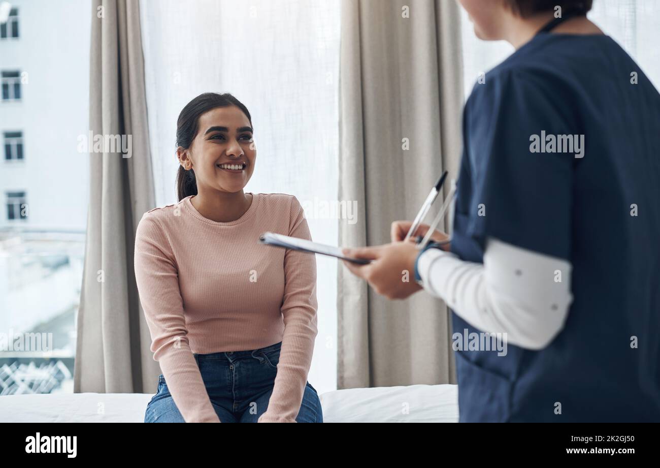 You dont have to worry about it so much. Shot of an unrecognizable doctor writing down a patients information in an office. Stock Photo