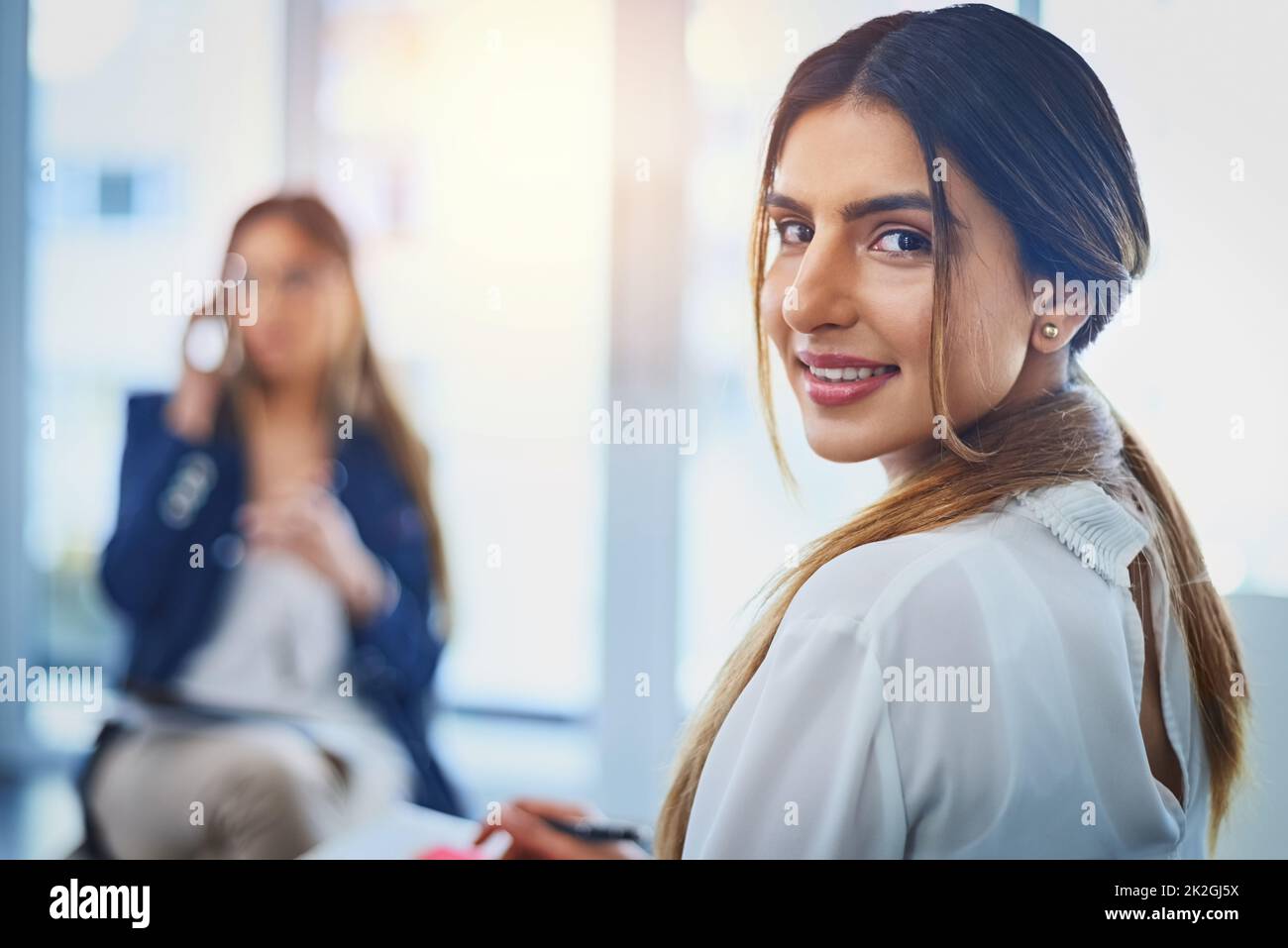 Were the ones who turn your ideas into reality. Portrait of an attractive young businesswoman taking down notes on her notepad during a meeting with her colleagues at work. Stock Photo