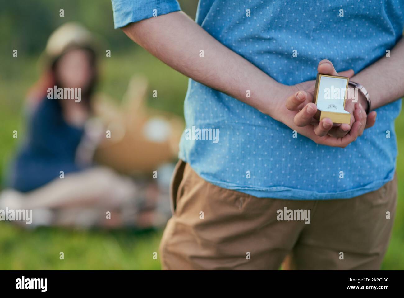 Hes about to mark his eternal love for her. Rear view shot of a man about to propose to his girlfriend with an engagement ring in a box. Stock Photo