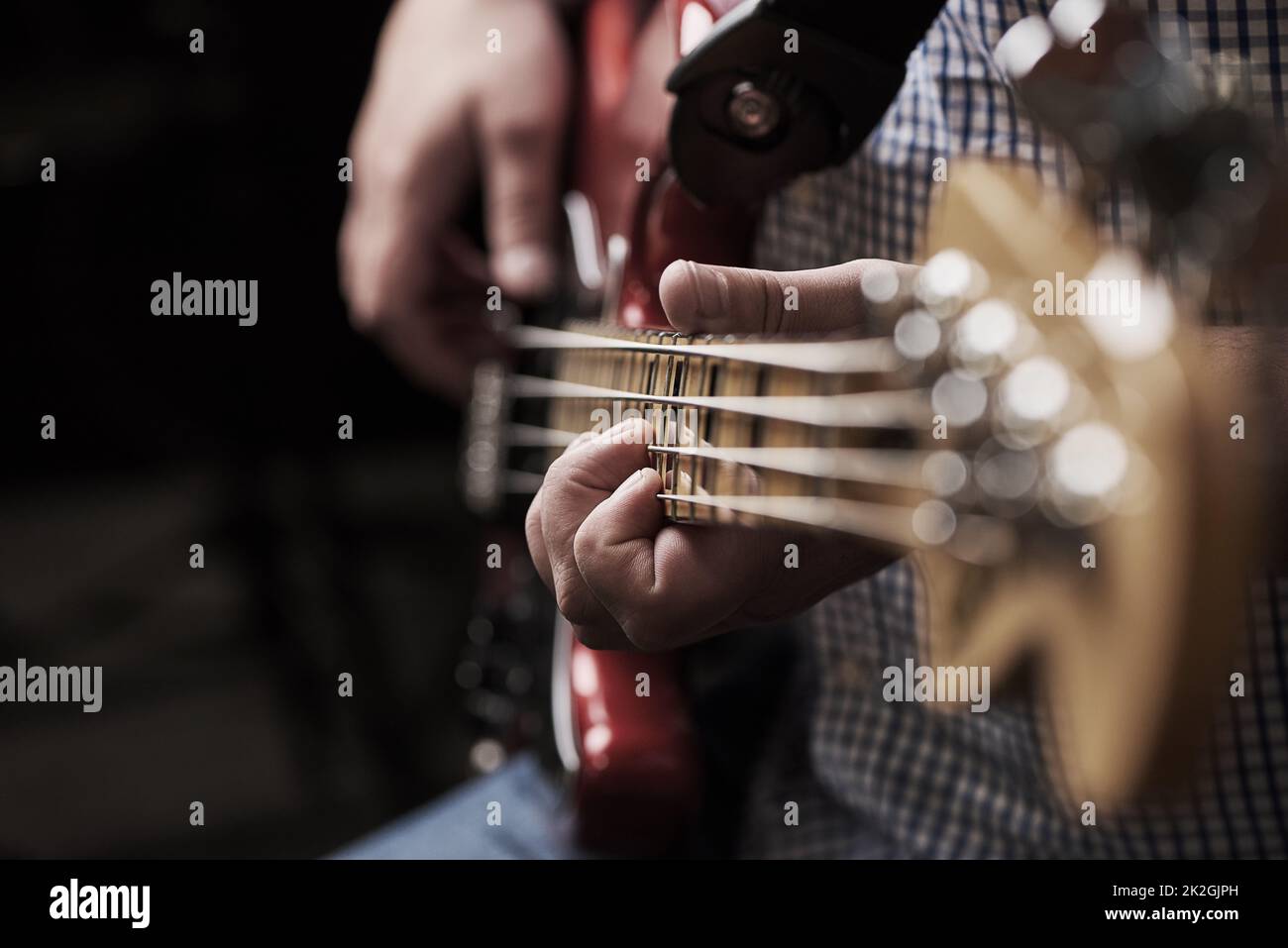 I am my own rockstar. Cropped shot of an unrecognizable man playing an electric guitar at home. Stock Photo