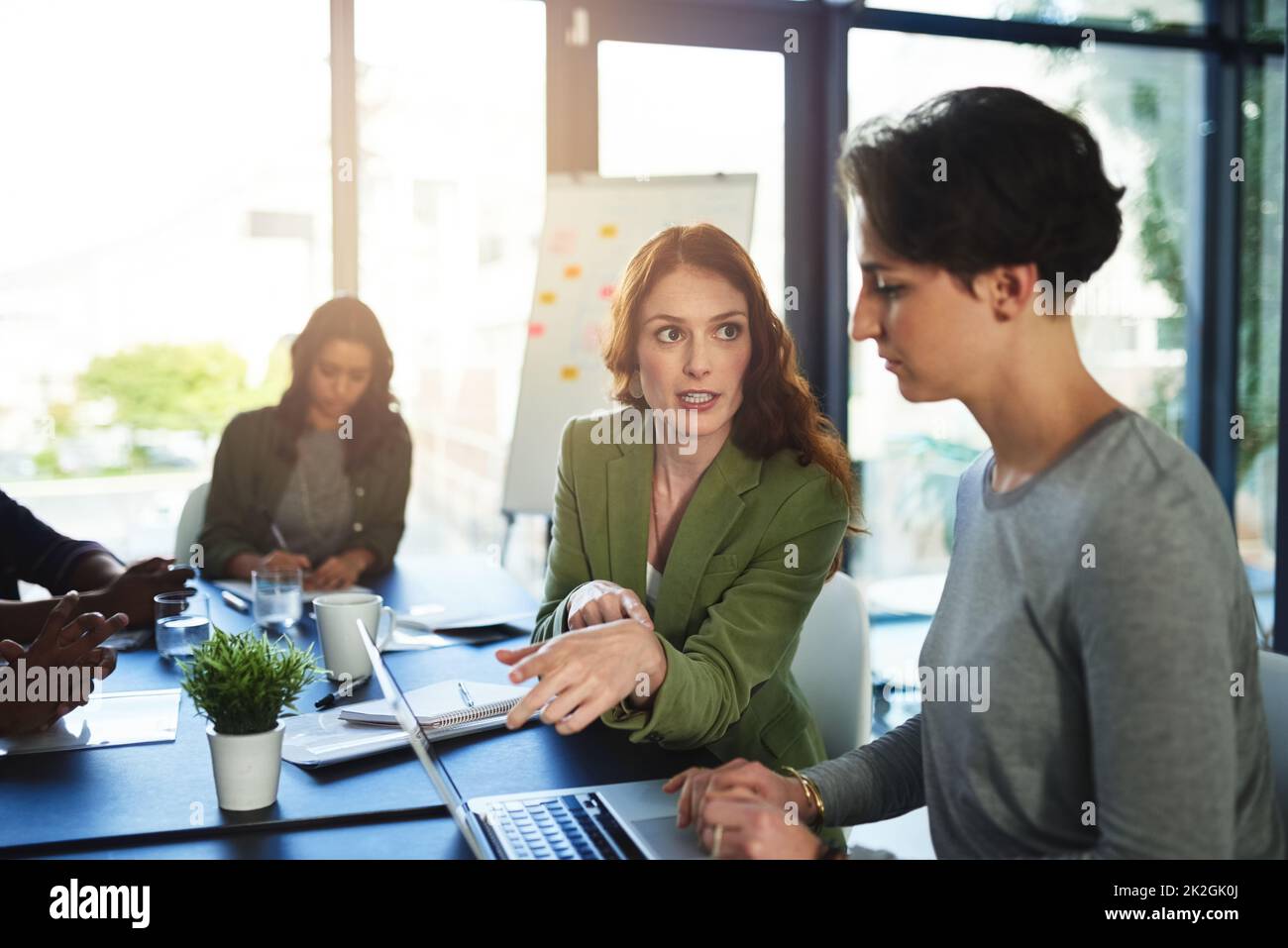 Putting the details into perspective. Shot of a group of businesswomen working in an office. Stock Photo