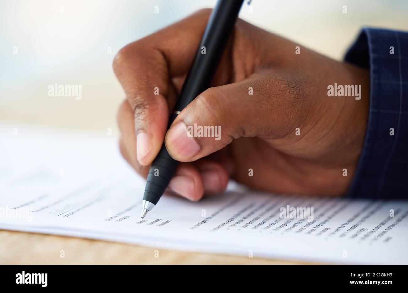 Without insurance, what certainty do you have. Shot of an unrecognisable businessman filling in a form on a desk in an office. Stock Photo