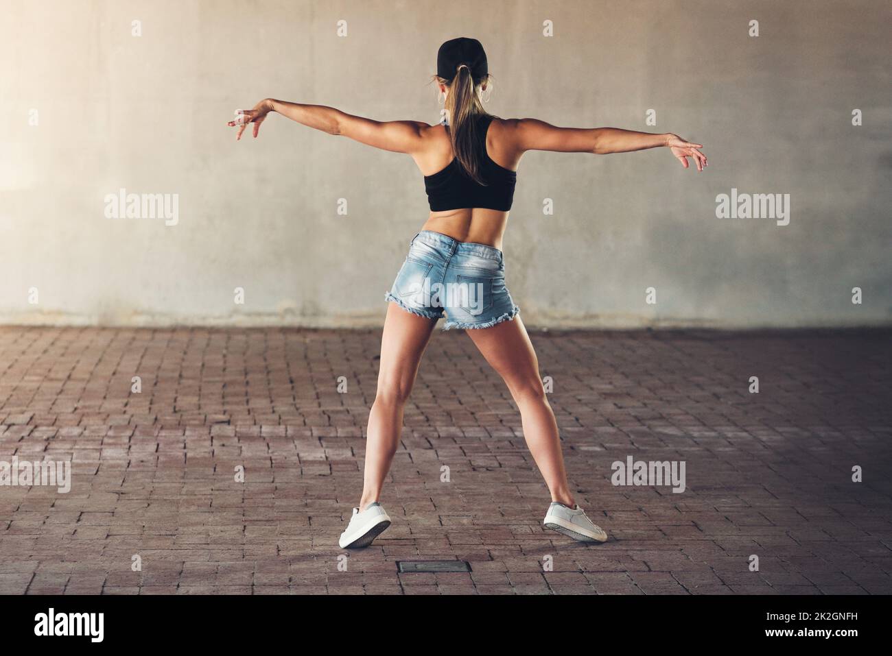 Shes getting her groove back. Rearview shot of a female street dancer