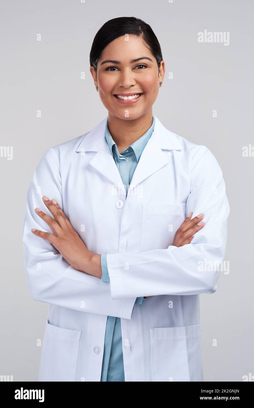 I was born for the lab. Cropped portrait of an attractive young female scientist standing with her arms folded in studio against a grey background. Stock Photo